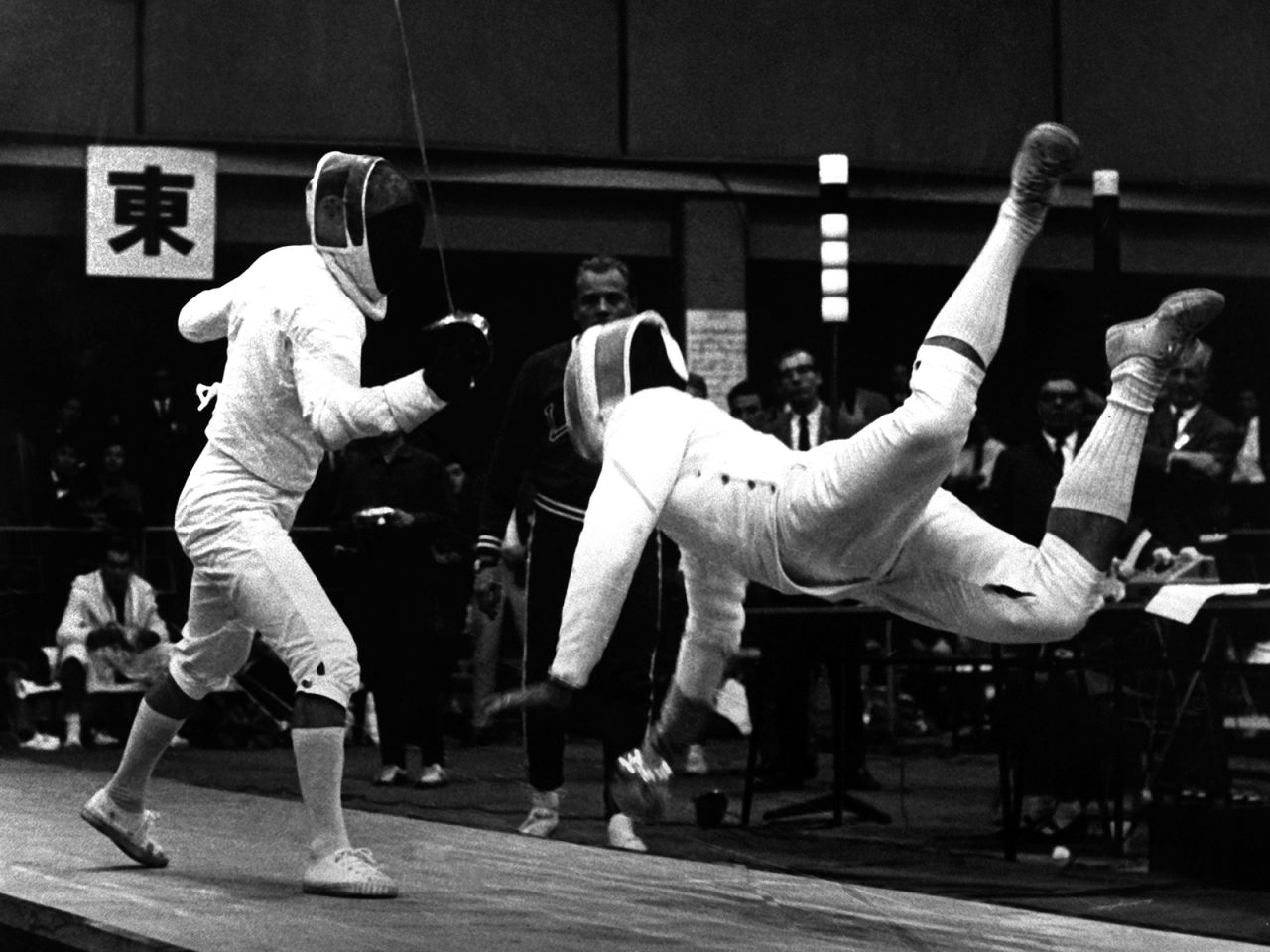 German fencer Walter Kostner goes airborne during a match against Poland's Jerzy Pawlowski.