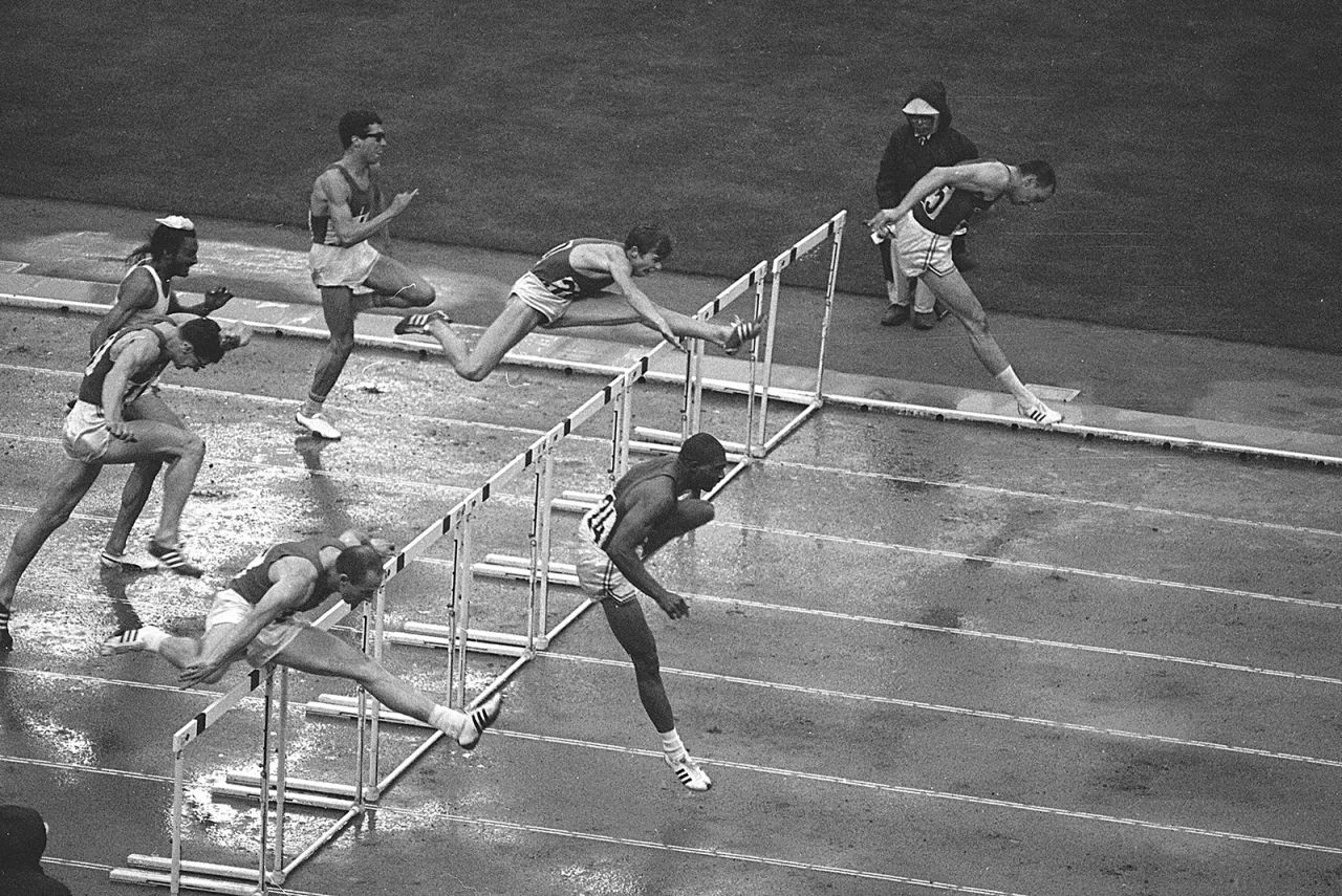 Athletes clear the last hurdle in the 110-meter event. American Hayes Jones, bottom right, won the gold.