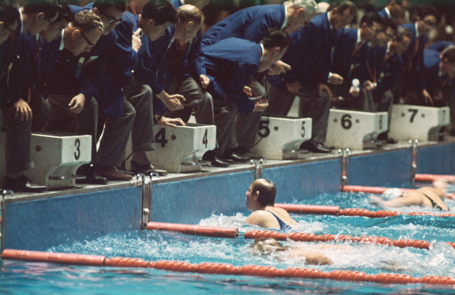 American swimmer Sharon Stouder finishes a stroke ahead of the Netherlands' Ada Kok to win the 100-meter butterfly. Stouder, who was 15 years old, won three gold medals while in Tokyo.