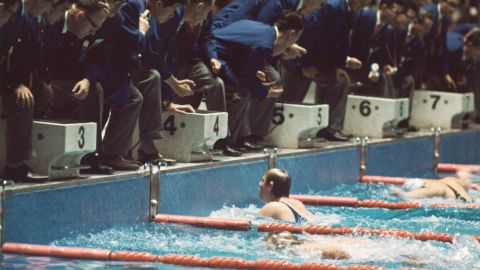 American swimmer Sharon Stouder finishes a stroke ahead of the Netherlands' Ada Kok to win the 100-meter butterfly. Stouder, who was 15 years old, won three gold medals while in Tokyo.
