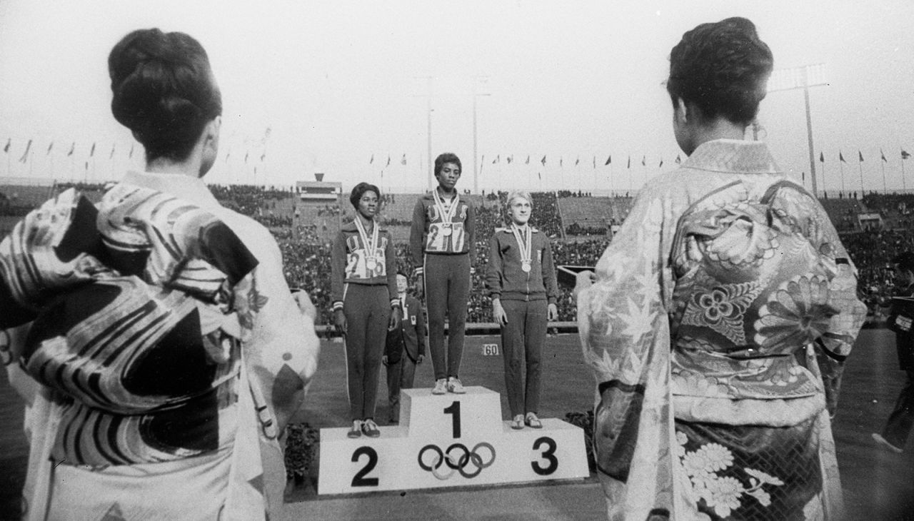 Sprinters stand on the podium after the 100-meter dash. American Wyomia Tyus won gold, compatriot Edith McGuire won silver, and Poland's Ewa Klobukowska won bronze.