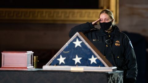 A Capitol Police Officer pays her respects before a ceremony memorializing U.S. Capitol Police Officer Brian D. Sicknick, 42, as he lies in honor in the Rotunda of the Capitol on Wednesday, February 3, 2021 