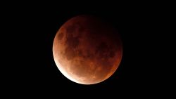 SYDNEY, AUSTRALIA - MAY 26: A super blood moon is seen during a total lunar eclipse on May 26, 2021 in Sydney, Australia. It is the first total lunar eclipse in more than two years, which coincides with a supermoon.  A super moon is a name given to a full (or new) moon that occurs when the moon is in perigee - or closest to the earth - and it is the moon's proximity to earth that results in its brighter and bigger appearance. (Photo by Cameron Spencer/Getty Images)