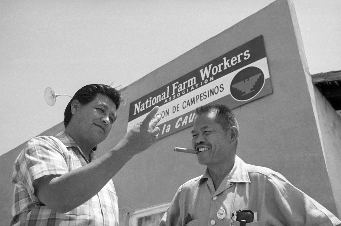 Larry Itliong, right, a Filipino-American labor leader and organizer with United Farm Workers leader Cesar Chavez, left,  in front of union headquarters.