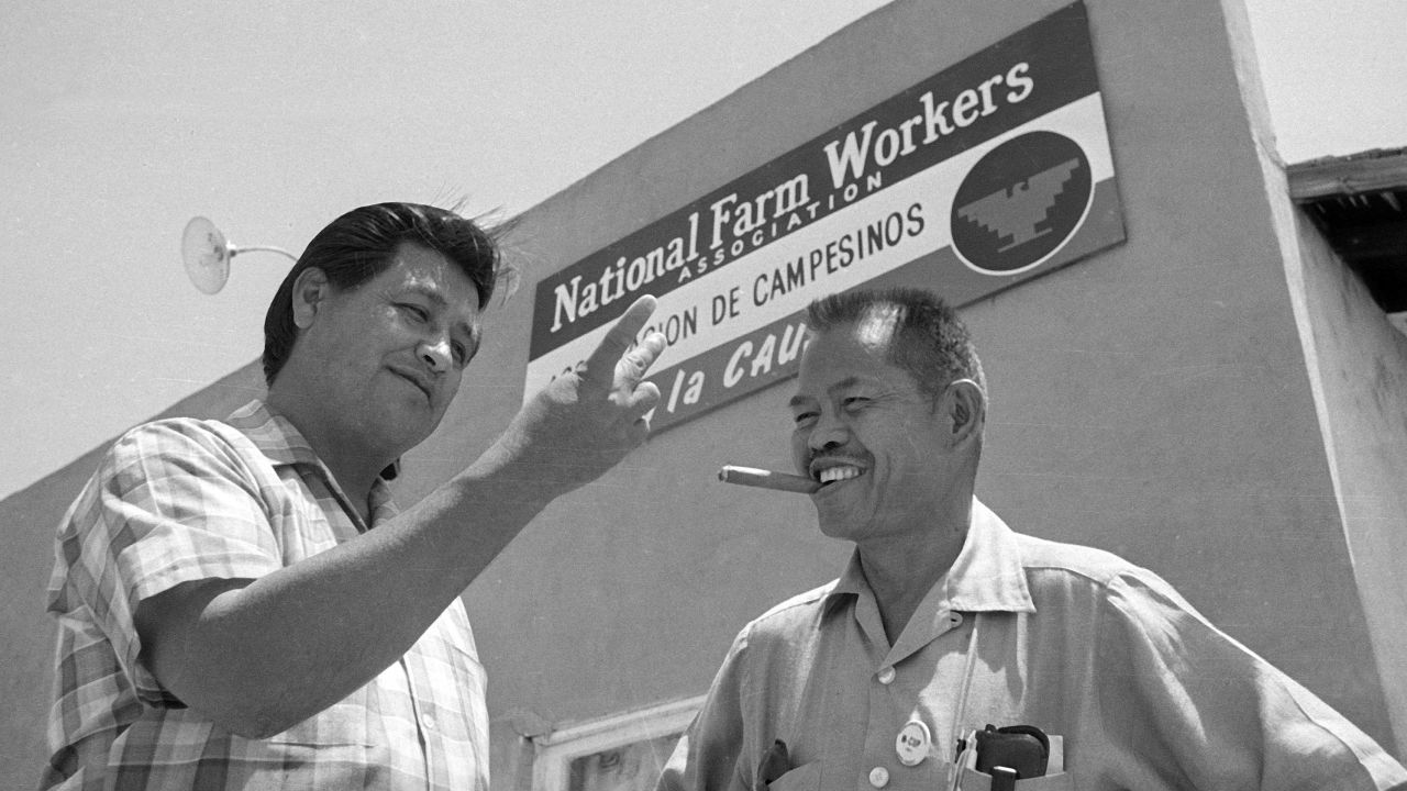 Larry Itliong, right, a Filipino-American labor leader and organizer with United Farm Workers leader Cesar Chavez, left,  in front of union headquarters.