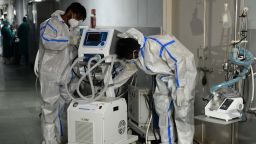 Health workers wearing protective gear place a defunct ventilator machine in the corridor of a hospital amid Covid-19 coronavirus pandemic in Amritsar on May 14, 2021. (Photo by NARINDER NANU / AFP) (Photo by NARINDER NANU/AFP via Getty Images)