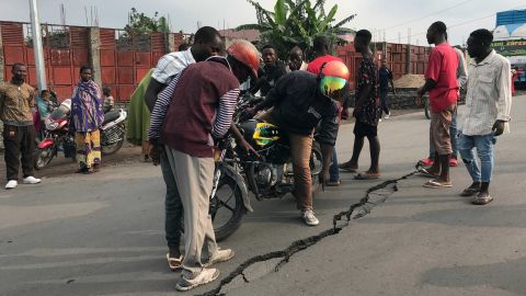 People look at a crack on the road caused by earth tremors following the eruption of Mount Nyiragongo volcano near Goma, in the Democratic Republic of Congo, on Wednesday, May 26.