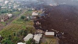 This aerial view shows debris engulfing buildings in Bushara village, Nyiragongo area, near Goma, on May 23, 2021, after a volcanic eruption of Mount Nyiragongo, that sent thousands fleeing during the night in eastern Democratic Republic of Congo. - A river of boiling lava from the eruption of Mount Nyiragongo has came to a halt outside Goma, sparing the city in the east of the Democratic Republic of Congo, the military governor of the region said on May 23, 2021. Five people were killed in related accidents. (Photo by Justin KATUMWA / AFP) (Photo by JUSTIN KATUMWA/AFP via Getty Images)