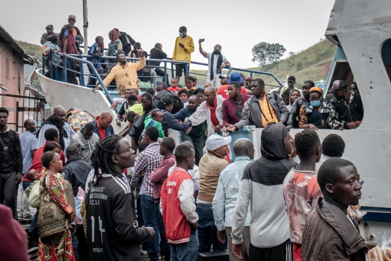 Goma residents board a ferry as they evacuate the city on May 27.