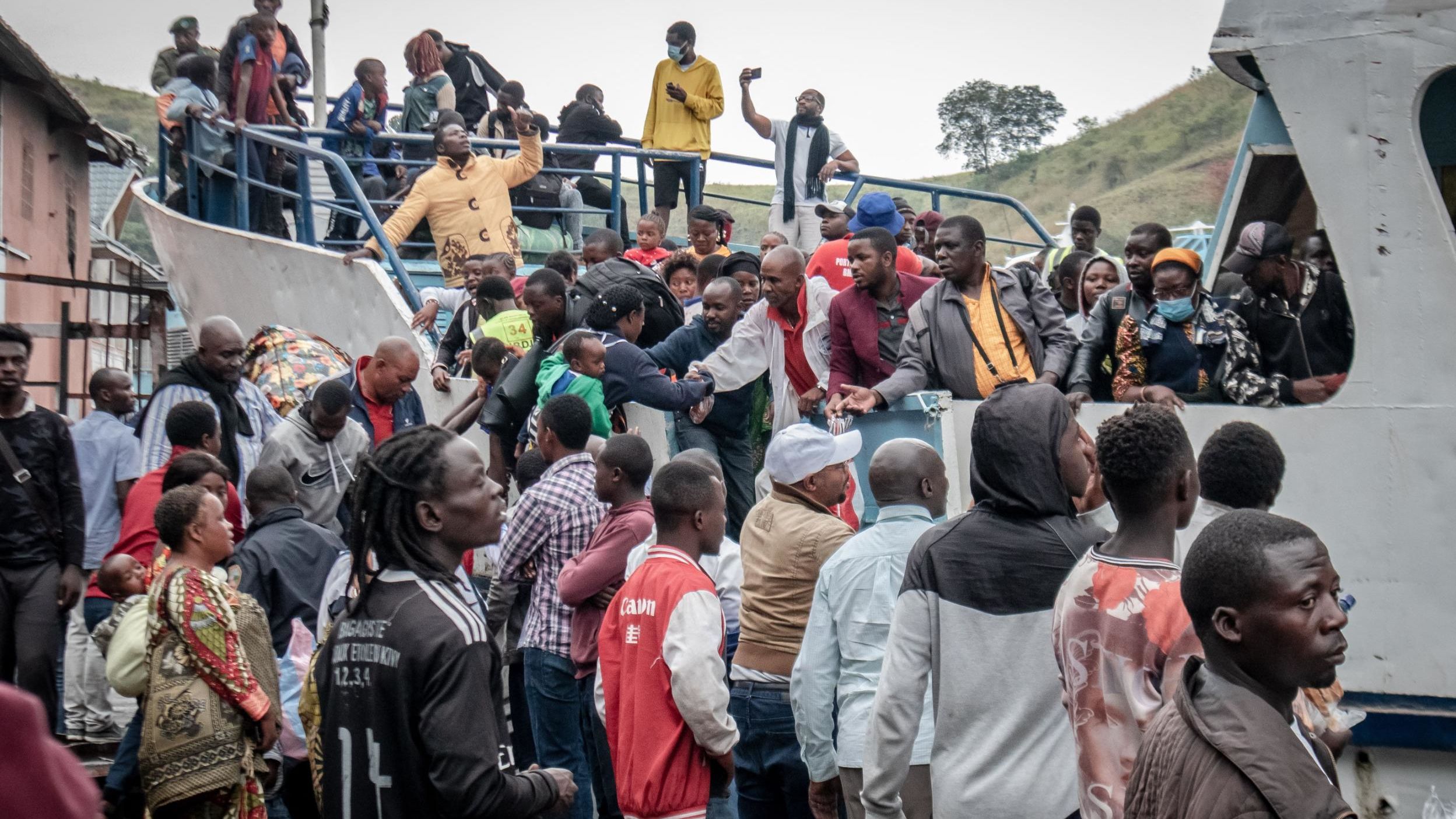 Goma residents board a ferry as they evacuate the city on May 27.