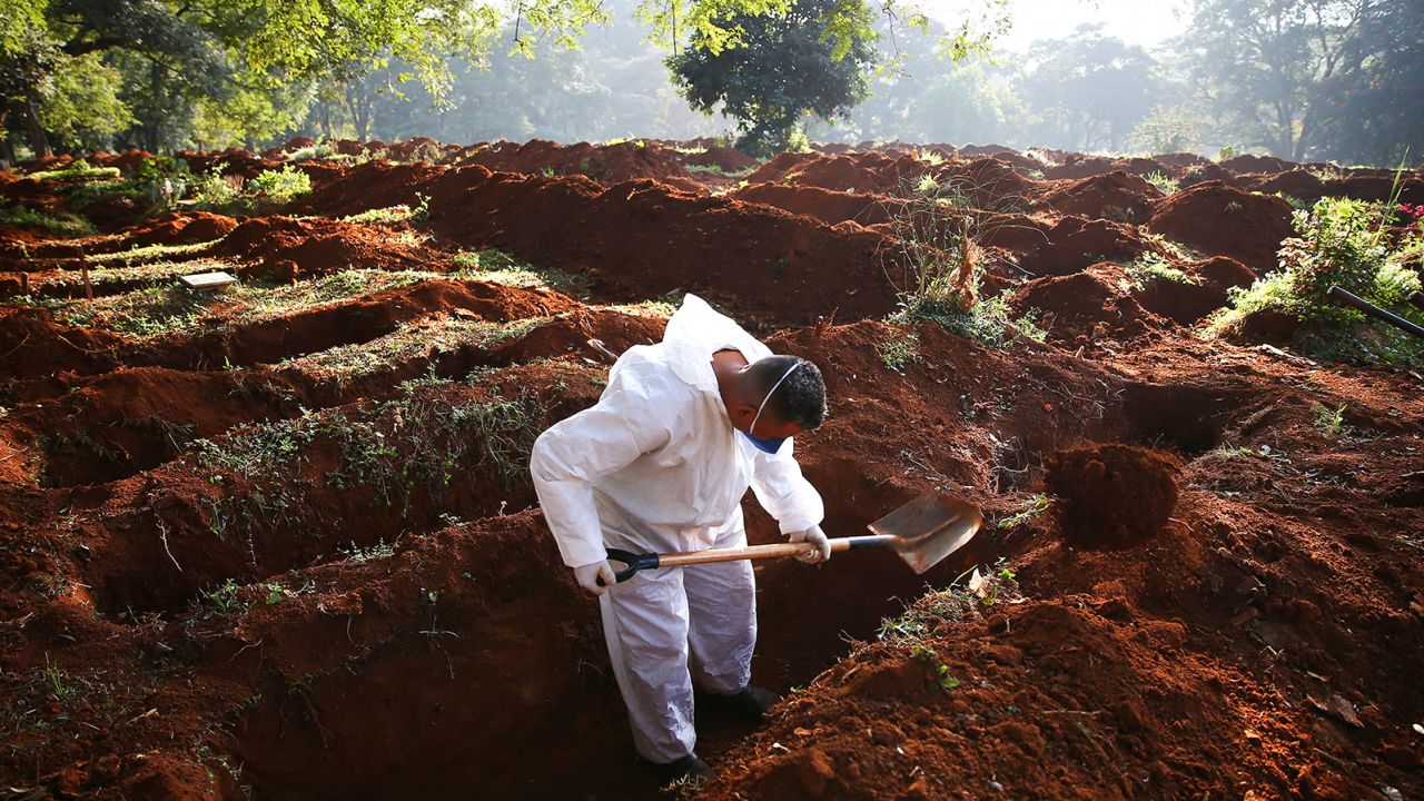 A cemetery worker digs graves for the bodies of people who died of Covid-19 in Sao Paulo this month.