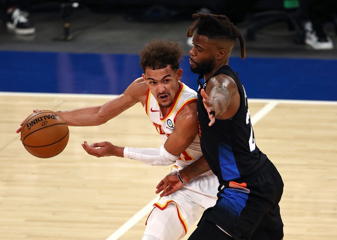 Atlanta Hawks' Trae Young, left, tries to get past New York Knicks' Reggie Bullock during the fourth quarter in Game 2 of the NBA playoffs. 