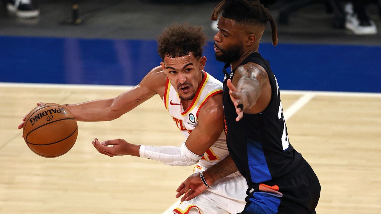 Atlanta Hawks' Trae Young, left, tries to get past New York Knicks' Reggie Bullock during the fourth quarter in Game 2 of the NBA playoffs. 