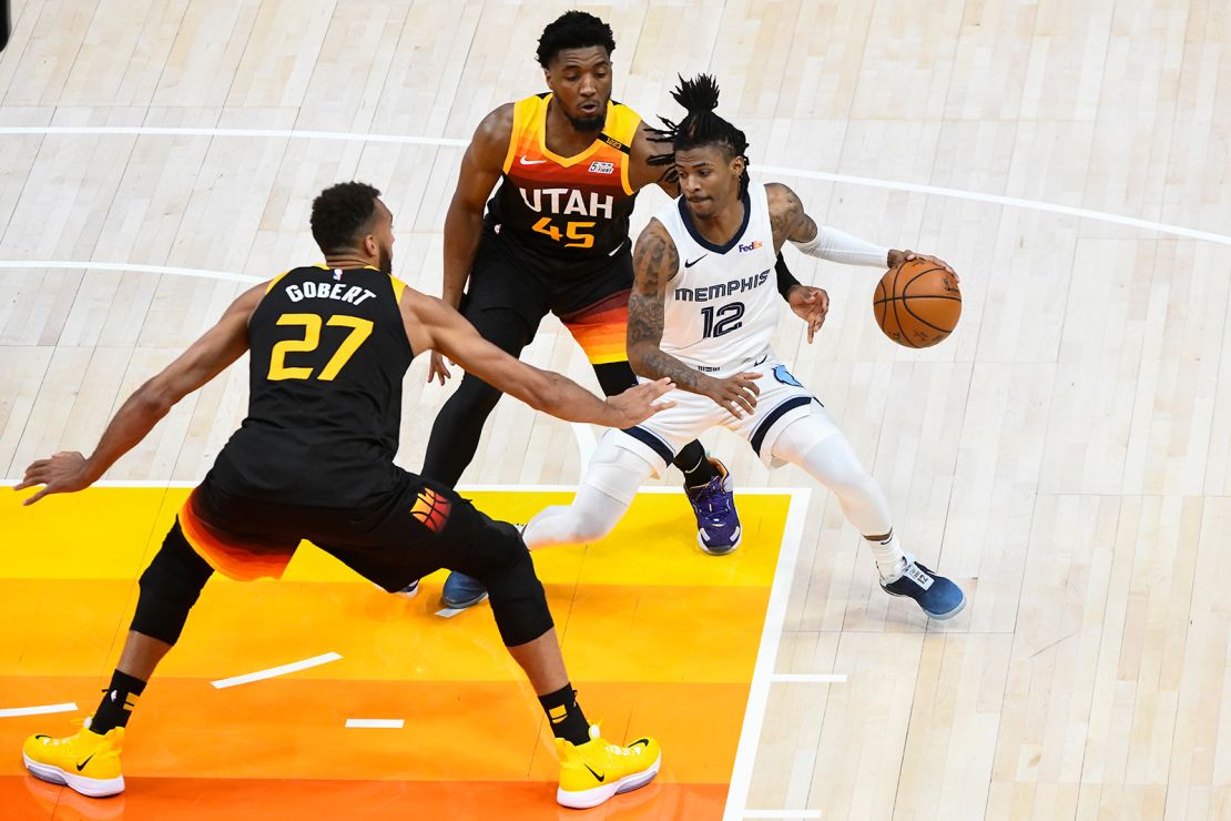Ja Morant of the Memphis Grizzlies attempts to drive between Donovan Mitchell and Rudy Gobert of the Utah Jazz in Game 2 of the Western Conference first-round playoff series on May 26, 2021.