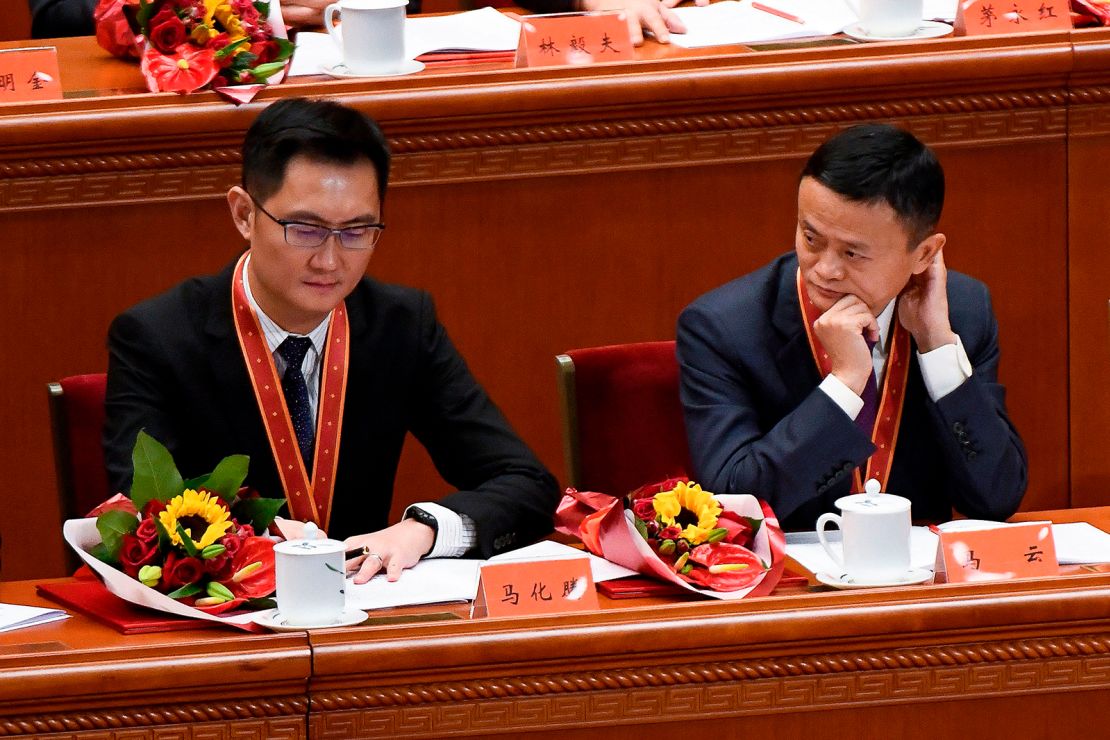 Alibaba's co-founder Jack Ma (R) looks at Tencent Holdings' CEO Pony Ma during a celebration meeting marking the 40th anniversary of China's "reform and opening up" policy at the Great Hall of the People in Beijing on December 18, 2018.