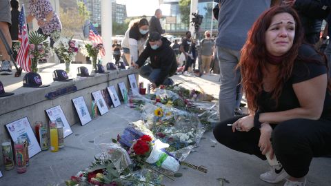  A mourner cries as she looks a a memorial for the nine VTA shooting victims during a vigil at San Jose City Hall.