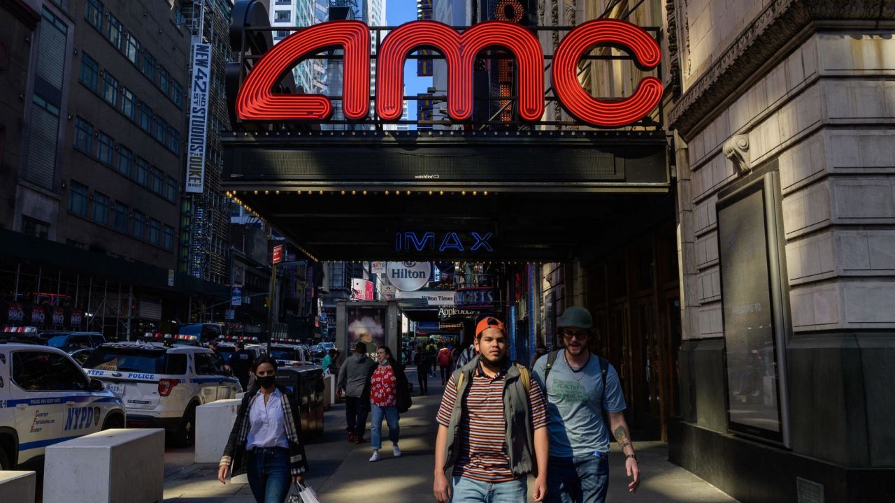 People walk past an AMC and IMAX movie theatre in the theatre district near Broadway on May 6, 2021 in New York City. - New York Governor Andrew Cuomo announced that Broadway will reopen on September 14, 2021  at one hundred percent capacity, with some tickets going on sale starting today. (Photo by Angela Weiss / AFP) (Photo by ANGELA WEISS/AFP via Getty Images)