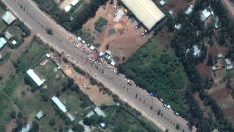 A crowd is seen outside the Guna distribution center on the outskirts of Shire, Ethiopia, in this satellite image captured on May 27. Detainees say they were beaten and tortured at the facility.
