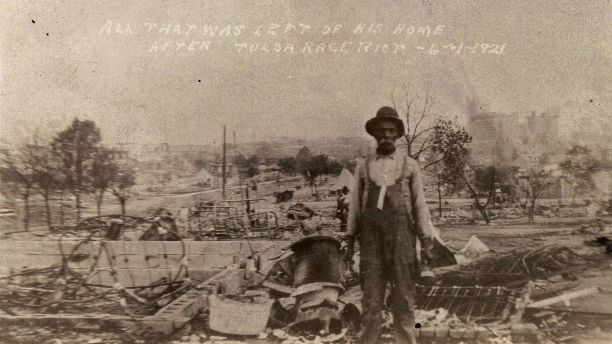 An unidentified man stands alone amid the ruins of what is described as his home in Tulsa, Okla., in the aftermath of the June, 1, 1921, Tulsa Race Massacre.