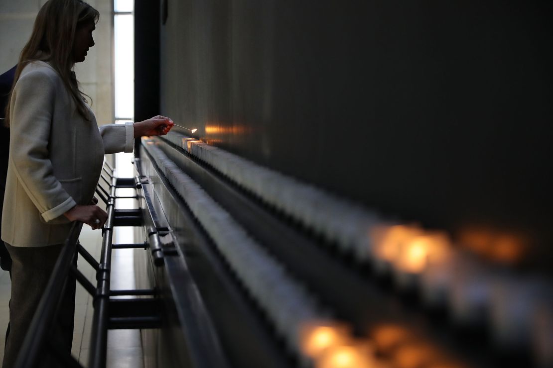 Susan Bourdeau lights a candle to commemorate International Holocaust Remembrance Day  on January 26, 2018, at the US Holocaust Memorial Museum in Washington.