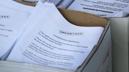 An unemployment application is seen in a box as City of Hialeah employees hand them out to people in front of the John F. Kennedy Library on April 8, 2020 in Hialeah, Florida.