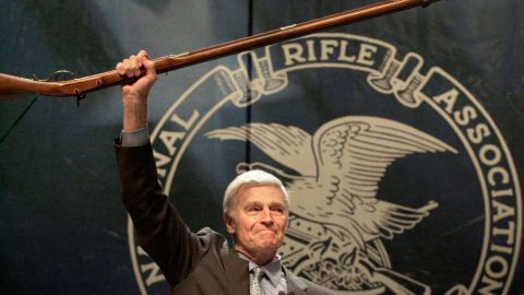 NRA president Charlton Heston holds up a musket at the group's 129th annual conference in May 2000 in Charlotte, North Carolina.