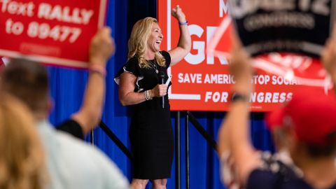 Rep. Marjorie Taylor Greene raises her fist while speaking during an America First rally in Dalton, Georgia, on Thursday. The event is one in a series she is co-hosting with Rep. Matt Gaetz, a Republican from Florida, across the country.