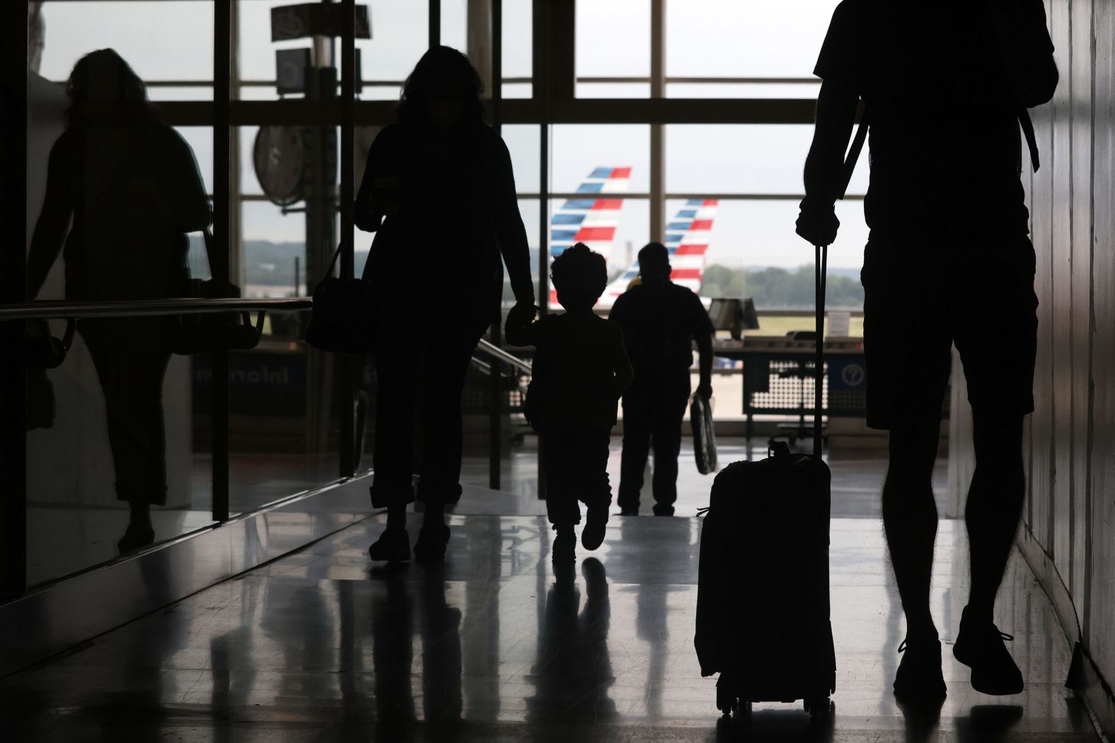 Travelers pass through the concourse Friday at Ronald Reagan Washington National Airport in Arlington, Virginia.