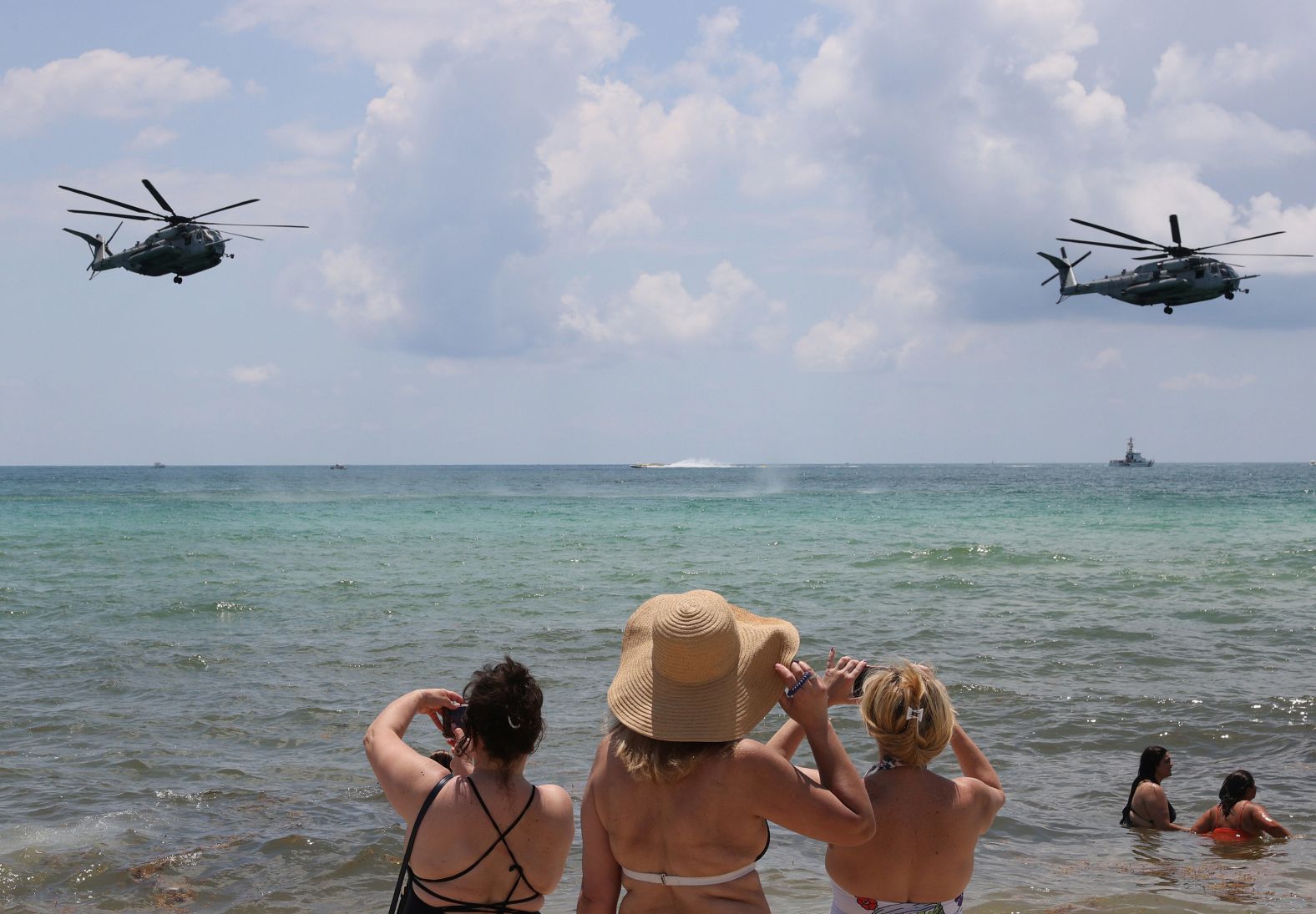 Beachgoers watch as US Marine helicopters practice maneuvers Friday for an air and sea show in Miami Beach, Florida.