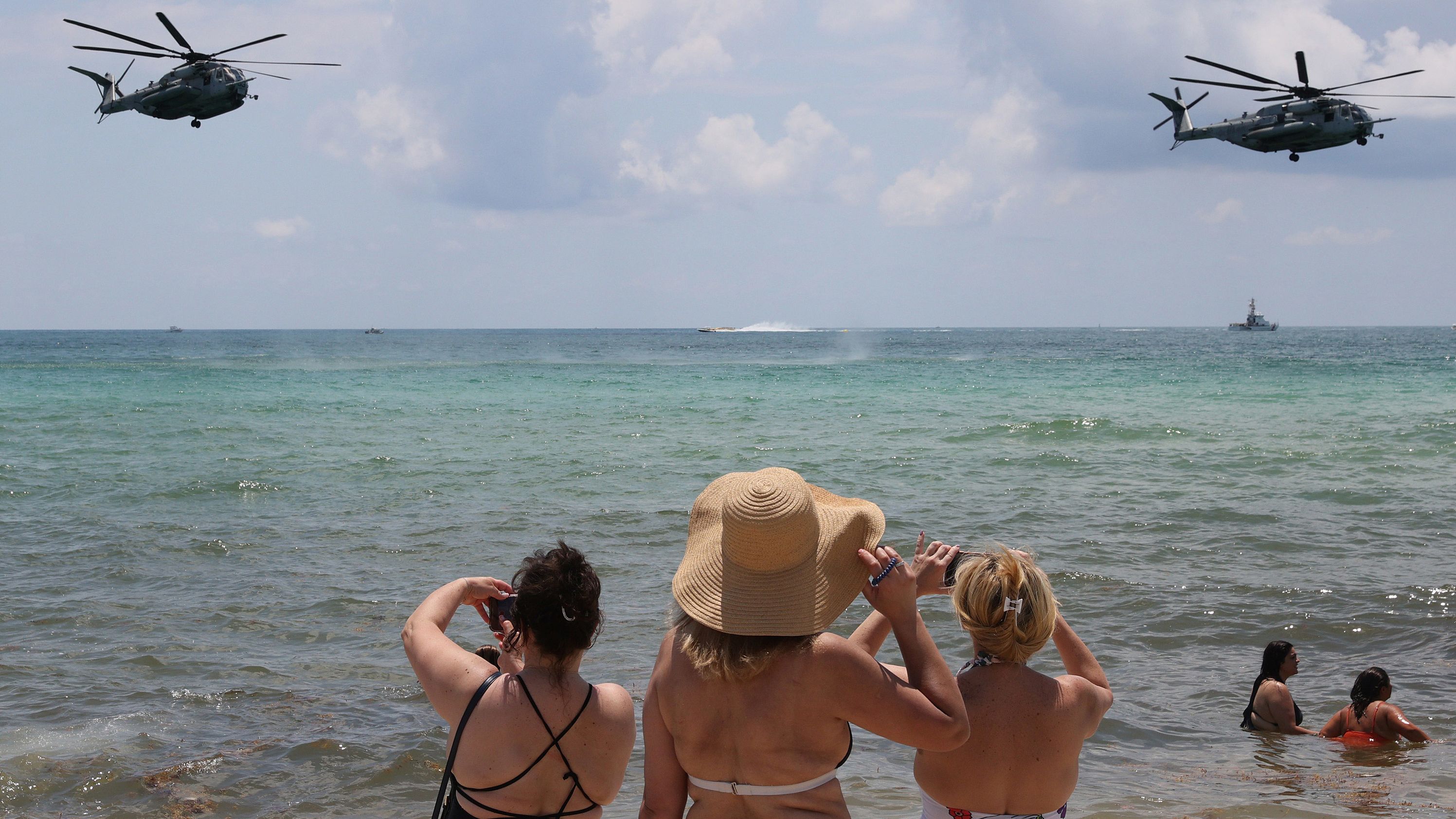 Beachgoers watch as US Marine helicopters practice maneuvers Friday for an air and sea show in Miami Beach, Florida.