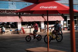 People ride along the boardwalk on the Jersey shore on May 27, 2021 in Wildwood, New Jersey.