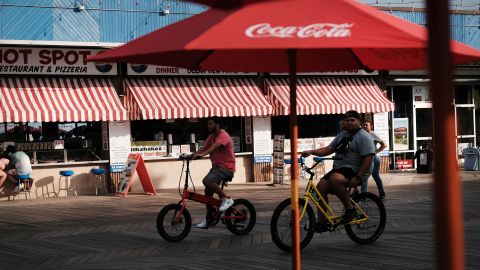 People ride along the boardwalk on the Jersey shore on May 27, 2021 in Wildwood, New Jersey. 