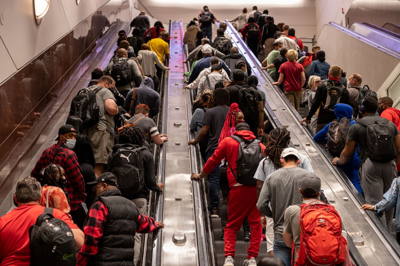 People ride escalators at Atlanta's Hartsfield-Jackson International Airport on Friday, May 28.