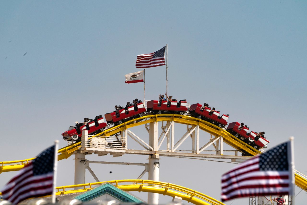 People ride a roller coaster at the pier in Santa Monica, California, on Saturday.