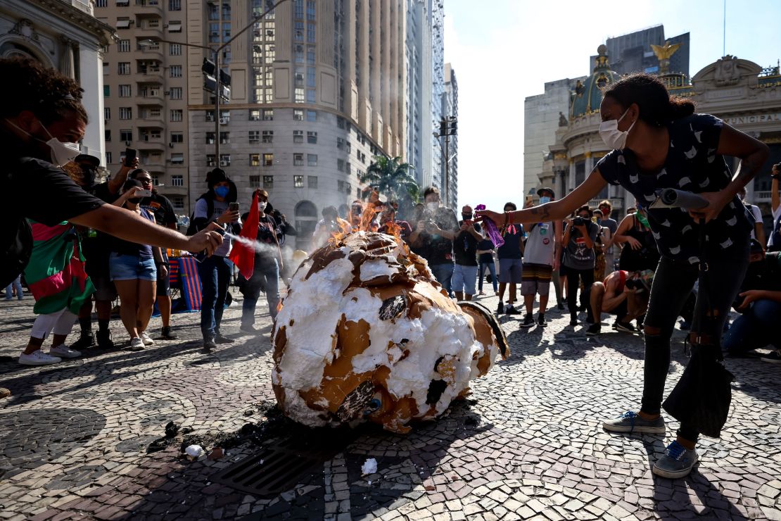Demonstrators set fire to an effigy of Bolsonaro in Rio de Janeiro.