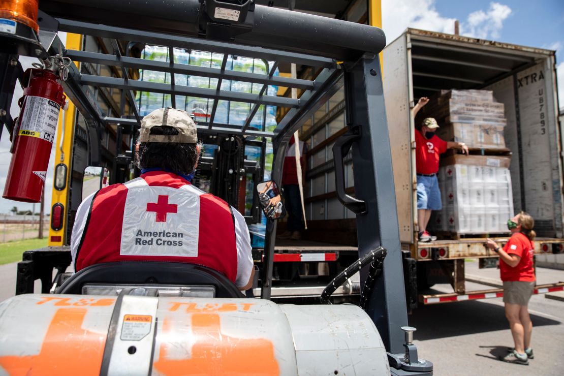 Volunteers for the American Red Cross unload items at warehouse in Mercedes, Texas, on Friday, July 31, 2020.