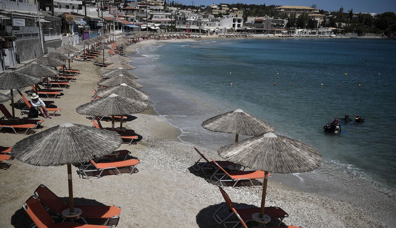 Umbrellas on a beach at Agia Pelagia on the Greek island of Crete were ready for tourists on May 14, 2021. Greece has eased restrictions for some international visitors while EU-wide policies are still being finalized.