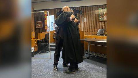 Edward Martell and Judge Bruce Morrow's hugging after Martell was sworn in.