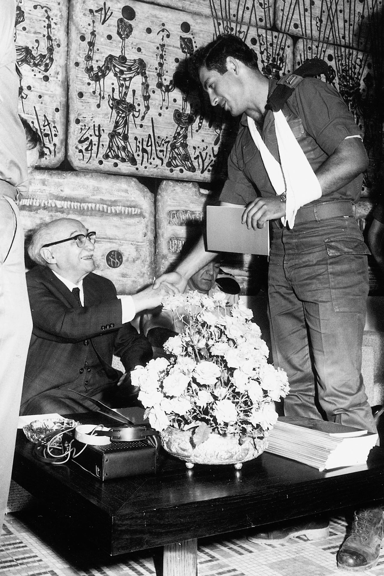 Netanyahu shakes hands with Israeli President Zalman Shazar during a 1972 ceremony honoring Sayeret Matkal soldiers who freed hostages in a hijacking earlier that year.