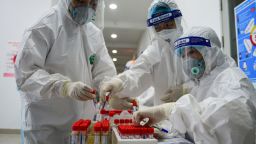 Health workers wearing personal protective equipment (PPE) collect swab samples to test for the Covid-19 coronavirus at the Thanh Xuan district medical centre in Hanoi on May 15, 2021. (Photo by Nhac NGUYEN / AFP) (Photo by NHAC NGUYEN/AFP via Getty Images)