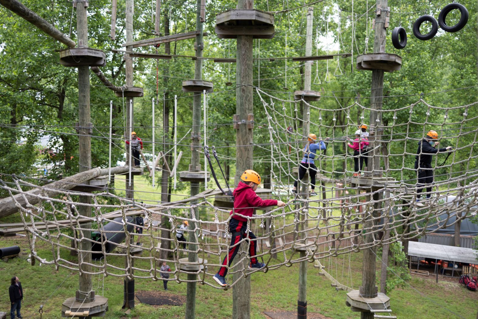 A boy makes his way through the aerial ropes course at Harpers Ferry Adventure Center in Hillsboro, Virginia, on Sunday.