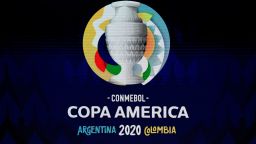 A screen displays the logo of the Copa America 2020 during the draw of the football tournament at the Convention Centre in Cartagena, Colombia, on December 3, 2019. - The Copa America 2020 football tournament will be held jointly by Argentina and Colombia next year from June 12 to July 12. Asian champions Qatar and previous winner Australia will participate as invited guest teams. (Photo by Juan BARRETO / AFP) (Photo by JUAN BARRETO/AFP via Getty Images)