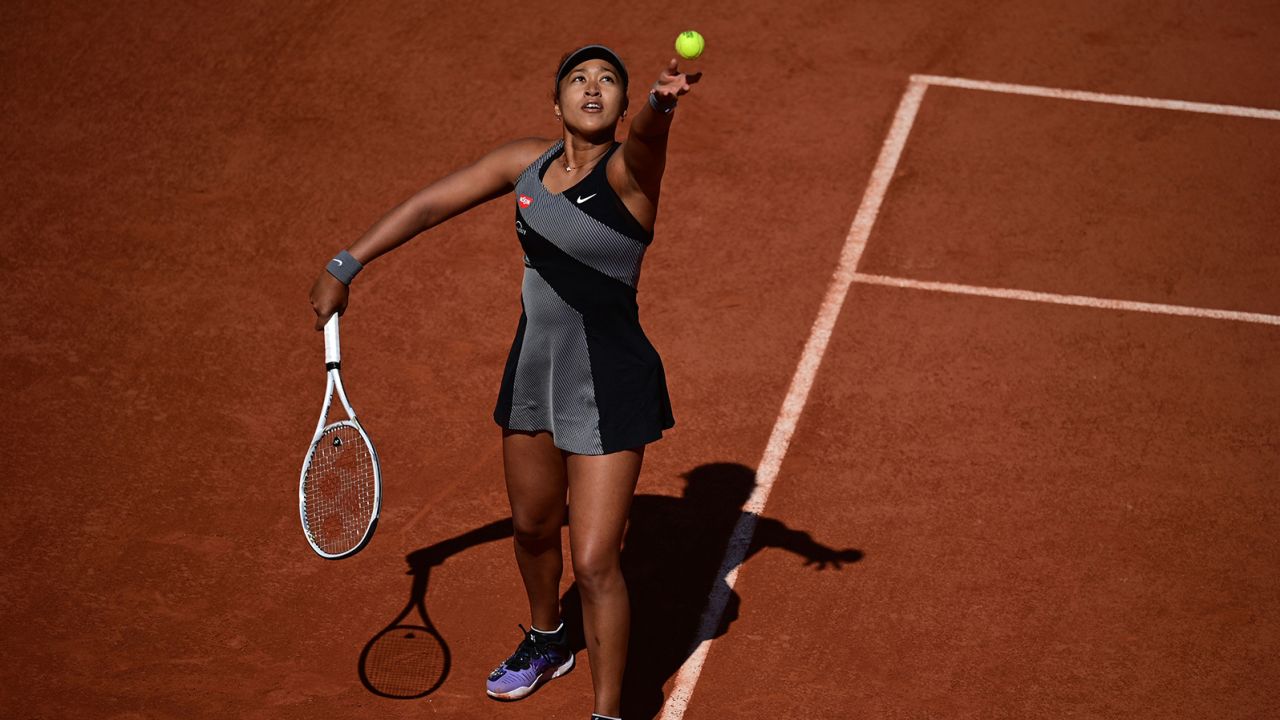 Before her announcement she was dropping out, Naomi Osaka serves the ball to Romania's Patricia Maria Tig on Day 1 of the French Open in Paris on May 30.