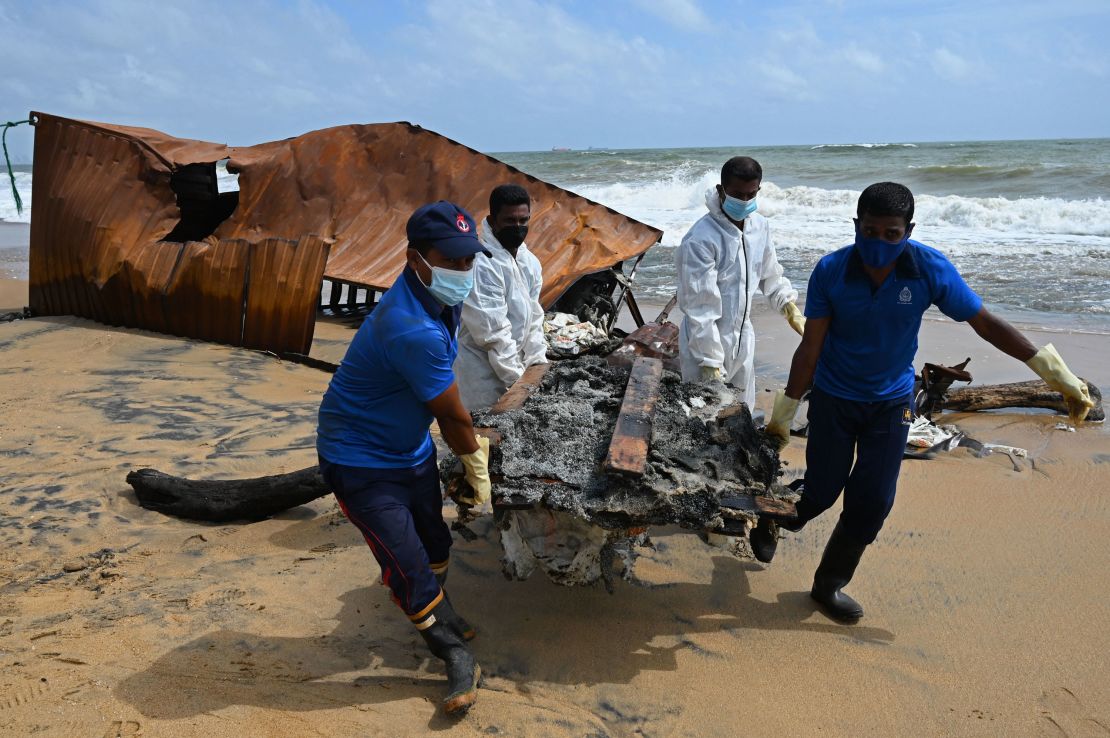 Members of Sri Lankan Navy remove debris washed ashore from the MV X-Press Pearl on a beach in Colombo on May 30.