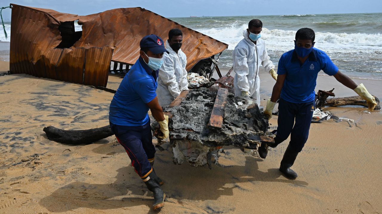 Members of Sri Lankan Navy remove debris washed ashore from the MV X-Press Pearl on a beach in Colombo on May 30.