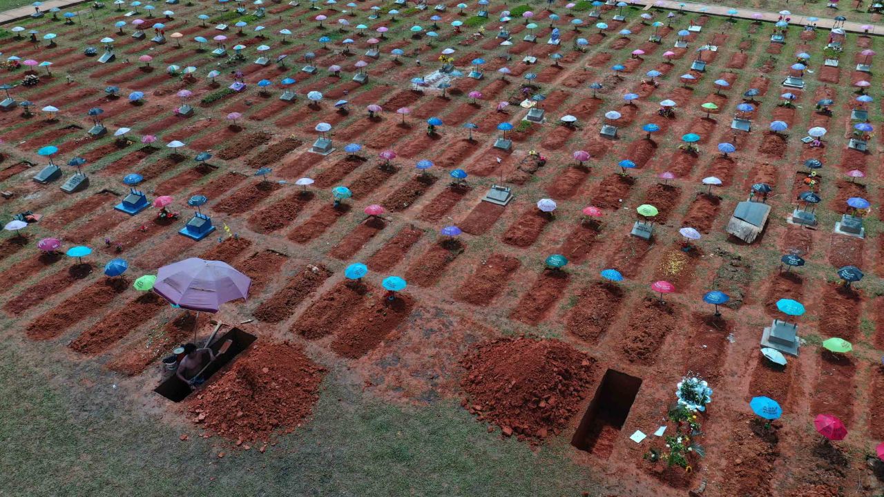 A worker digs a grave at a cemetery in Iquitos, Peru on March 20, 2021.