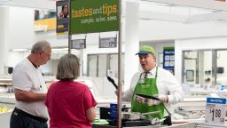 In this June 5, 2014 file photo, Rick Patanella, right, offers bacon samples to Karla and Gary Owens at Sam's Club in Bentonville, Ark. 