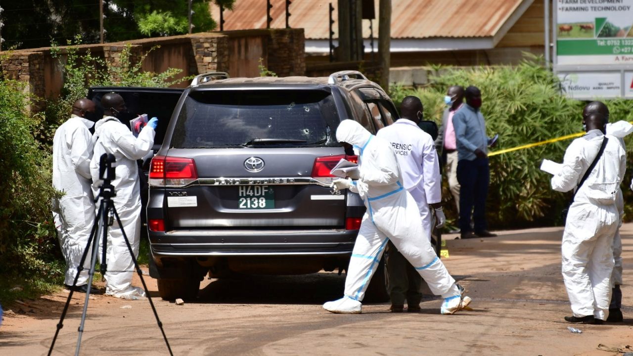 Forensic experts secure the scene outside the home of Ugandan minister of works and transport General Katumba Wamala.
