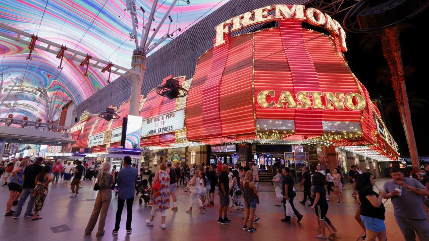 LAS VEGAS, NEVADA - MAY 31:  Visitors walk by the Fremont Hotel & Casino under the Viva Vision canopy attraction at the Fremont Street Experience on May 31, 2021 in Las Vegas, Nevada. Clark County is dropping all pandemic mandates as its COVID-19 mitigation plan expires at midnight on June 1, meaning businesses may operate at 100 percent capacity with no physical distancing restrictions.  (Photo by Ethan Miller/Getty Images)