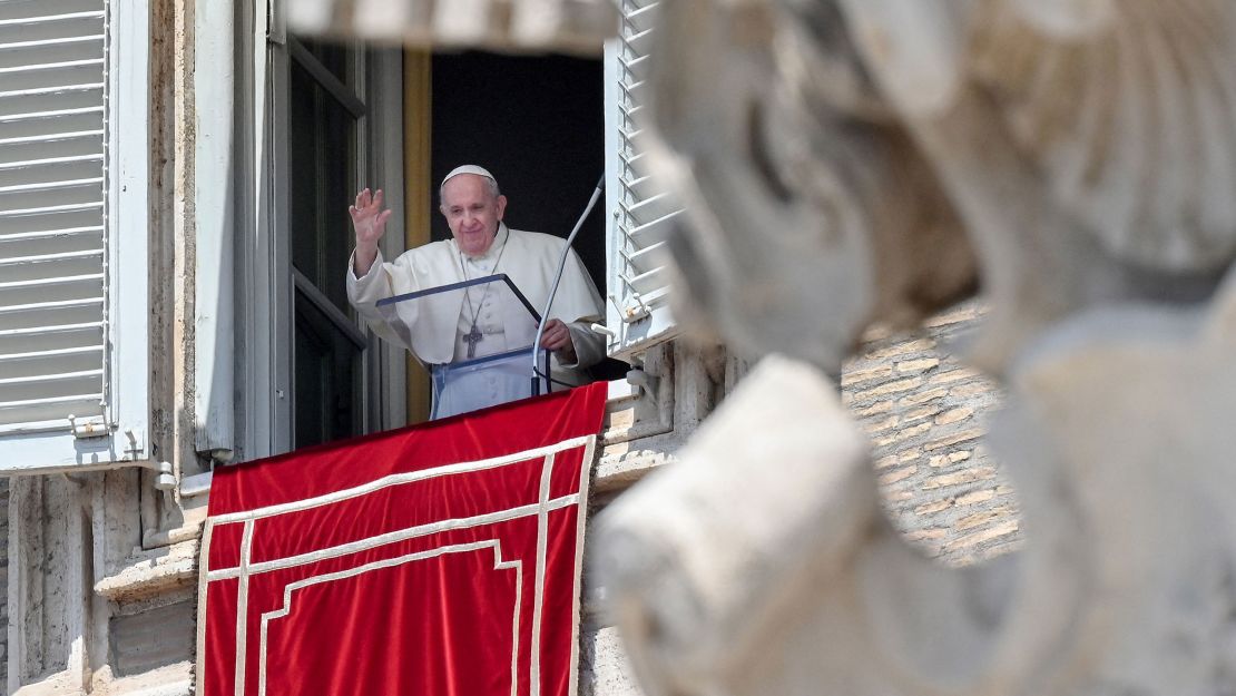 Pope Francis waves from a window overlooking St. Peter's Square in the Vatican during the weekly Angelus prayer followed by the recitation of the Regina Coeli on May 9, 2021.